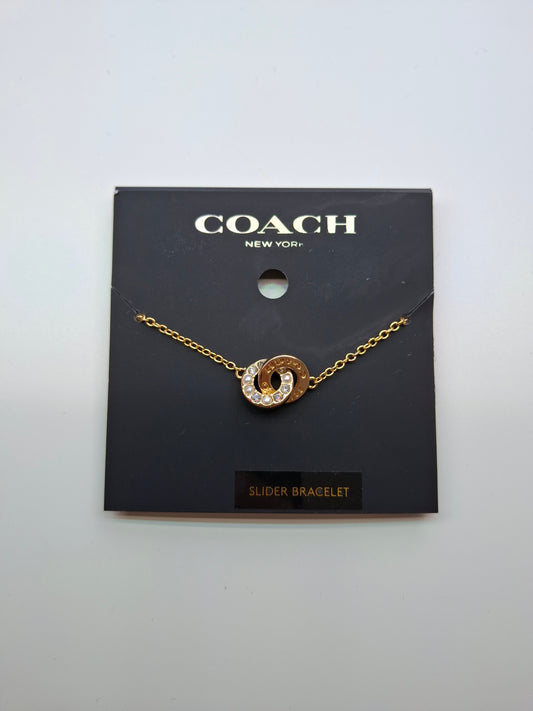Brazalete Coach